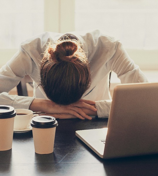 Tired woman drinking coffee