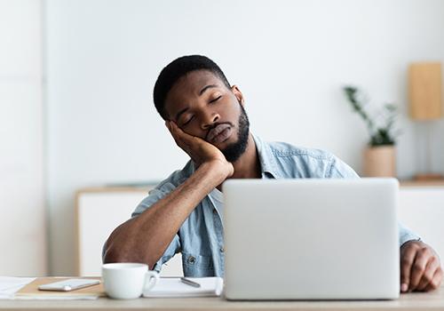Man falling asleep at his desk