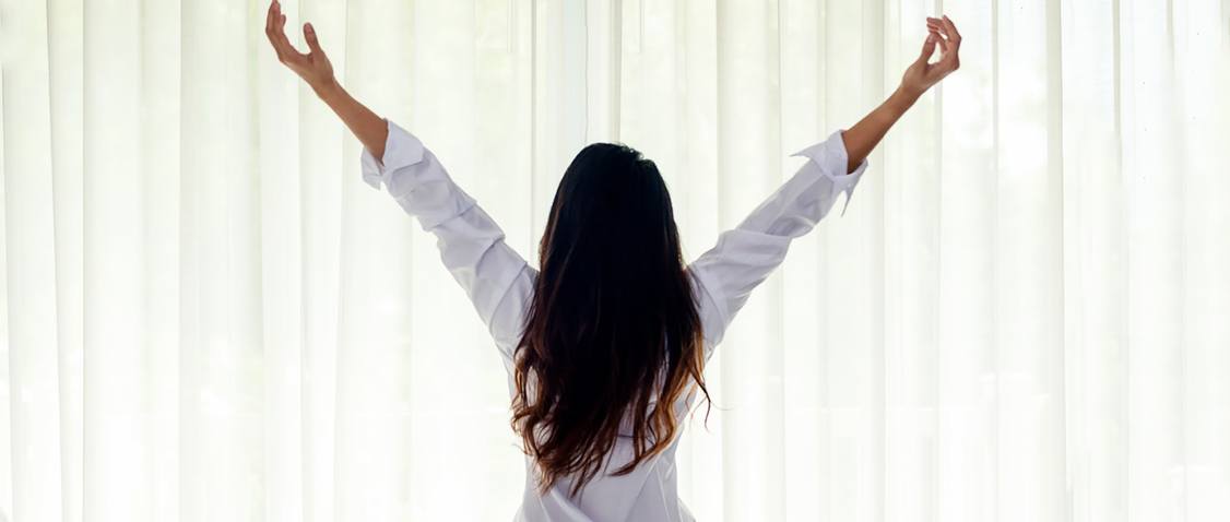 Woman waking up refreshed and happy thanks to combined therapy in Scottsdale