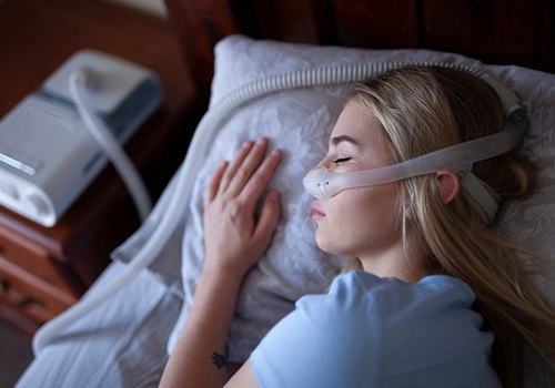 Woman sleeping with C P A P machine