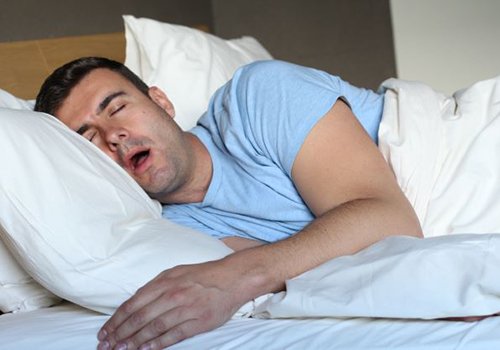 Snoring man who may need sleep apnea treatment