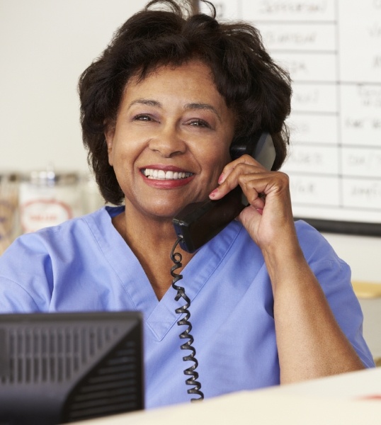 Smiling sleep center team member talking on phone