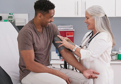 man having his blood pressure taken