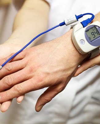 Dentist helping patient with a sleep test device