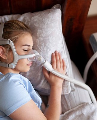 Woman sleeping peacefully with CPAP machine