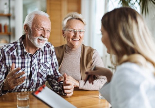 a mature couple talking about Medicare with their dentist 