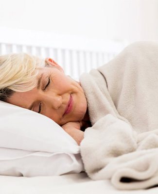 Woman sleeping peacefully with oral appliance.
